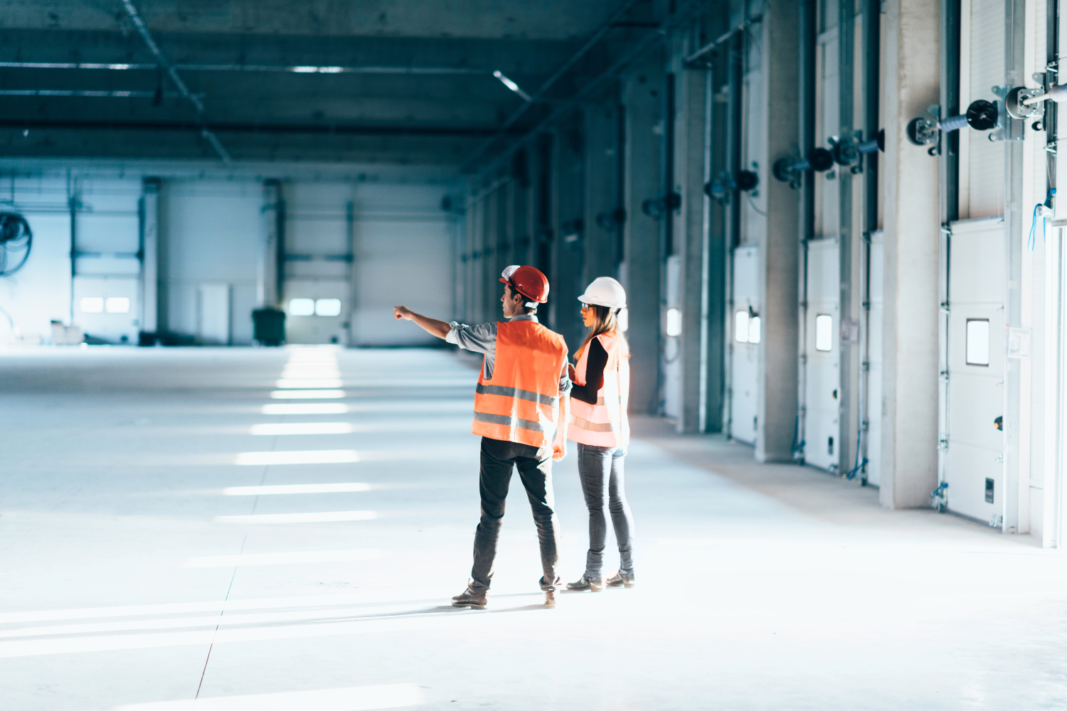 Two facility workers in a manufacturing facility.