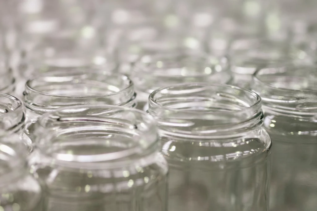 A close-up of clear glass supplement jars.