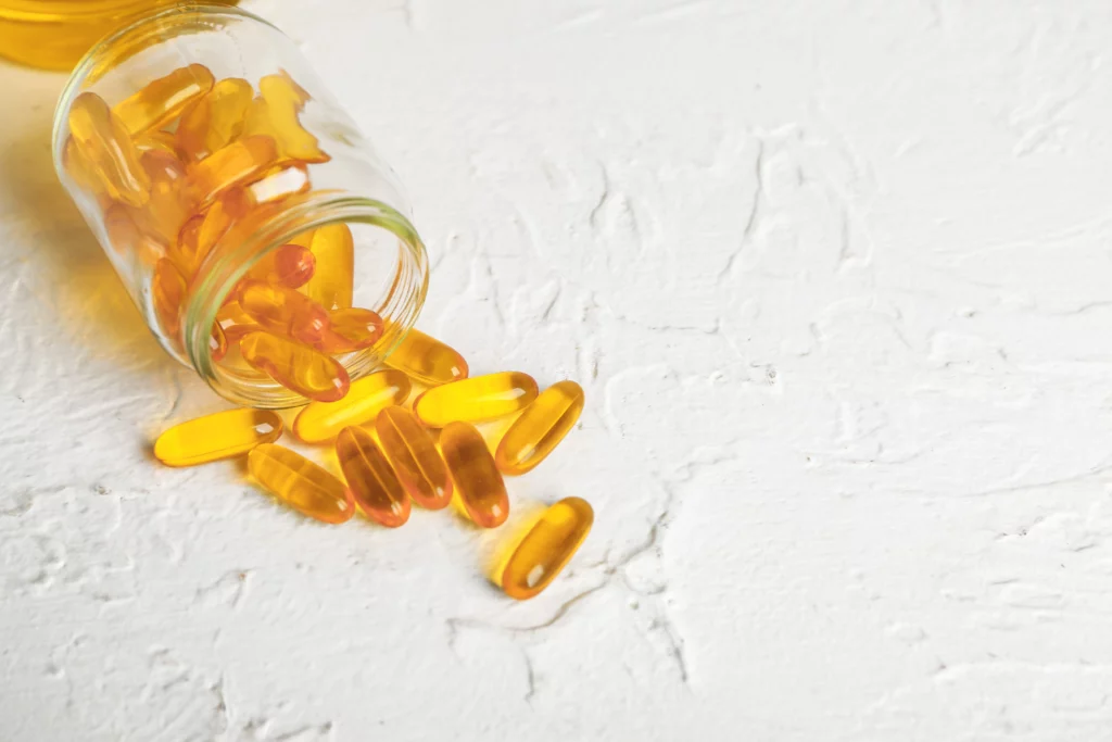 Glass supplement container with supplements spilling.