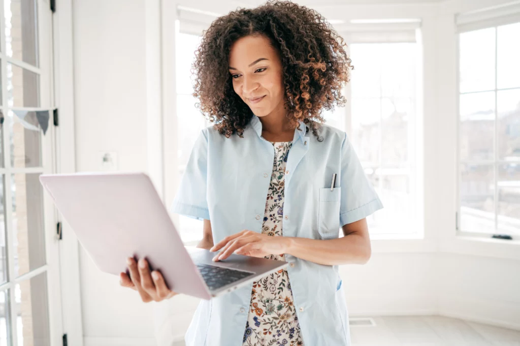 A health professional researching supplement ingredients on a laptop.