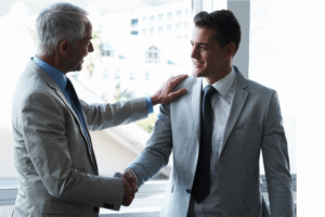 Two business professionals shaking hands.