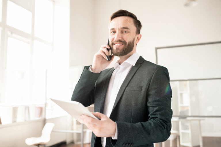 Business broker in formal attire speaking on phone and holding a tablet