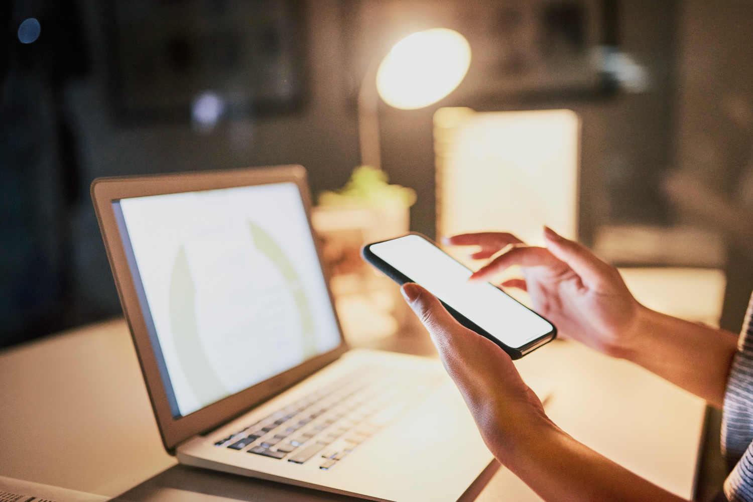 A laptop and a smartphone glowing.