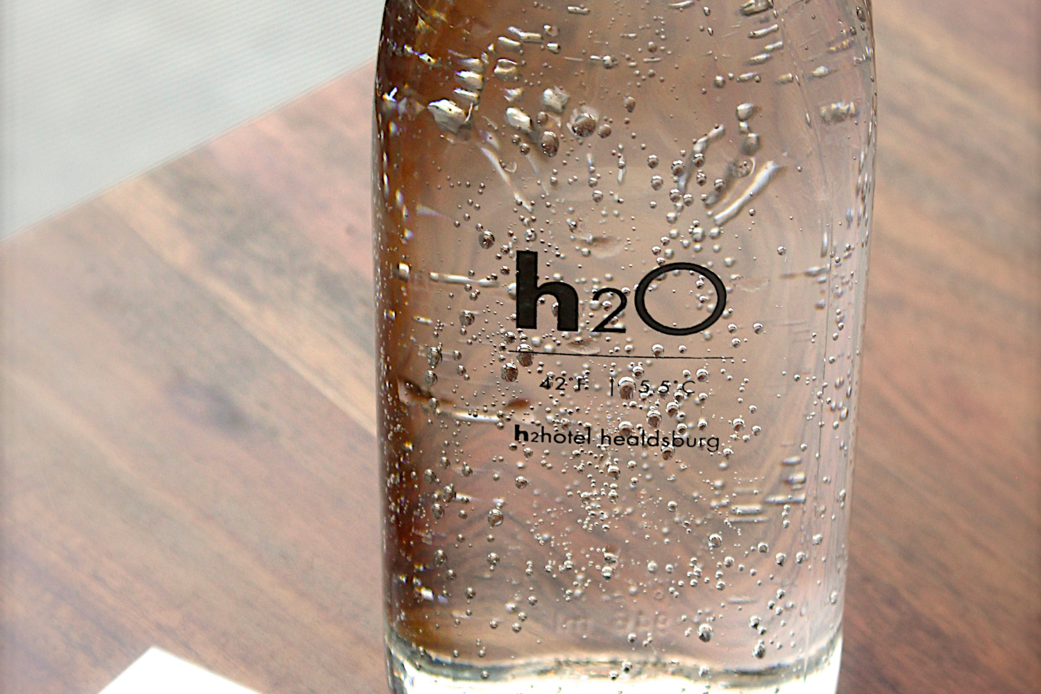 Glass bottle with a clear film label for a 'no-label' look.