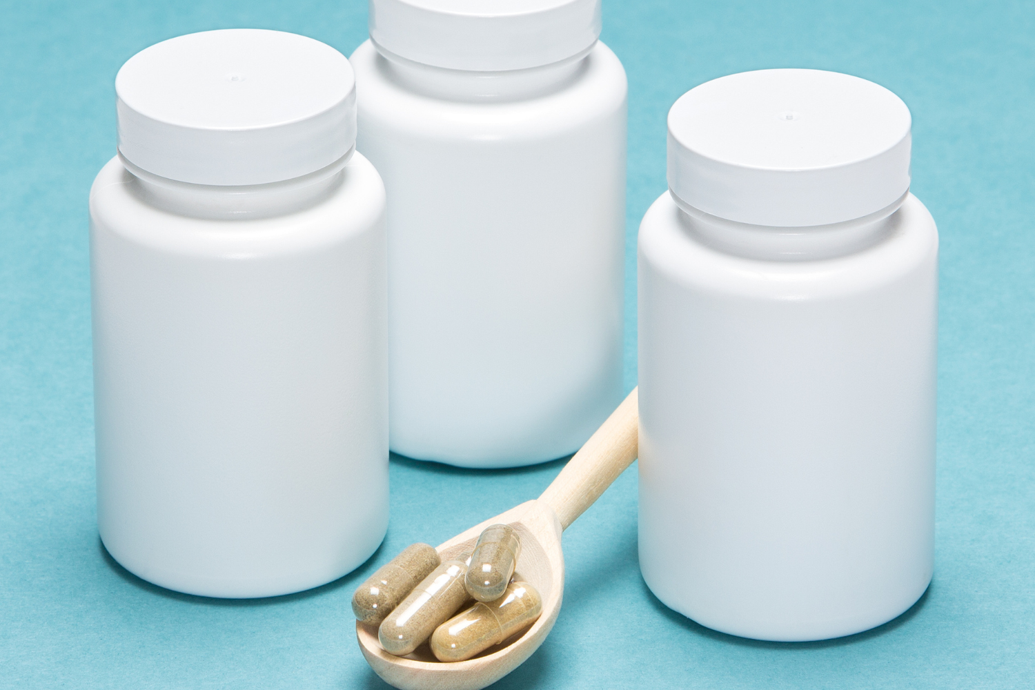 Three dietary supplement bottles without labels.