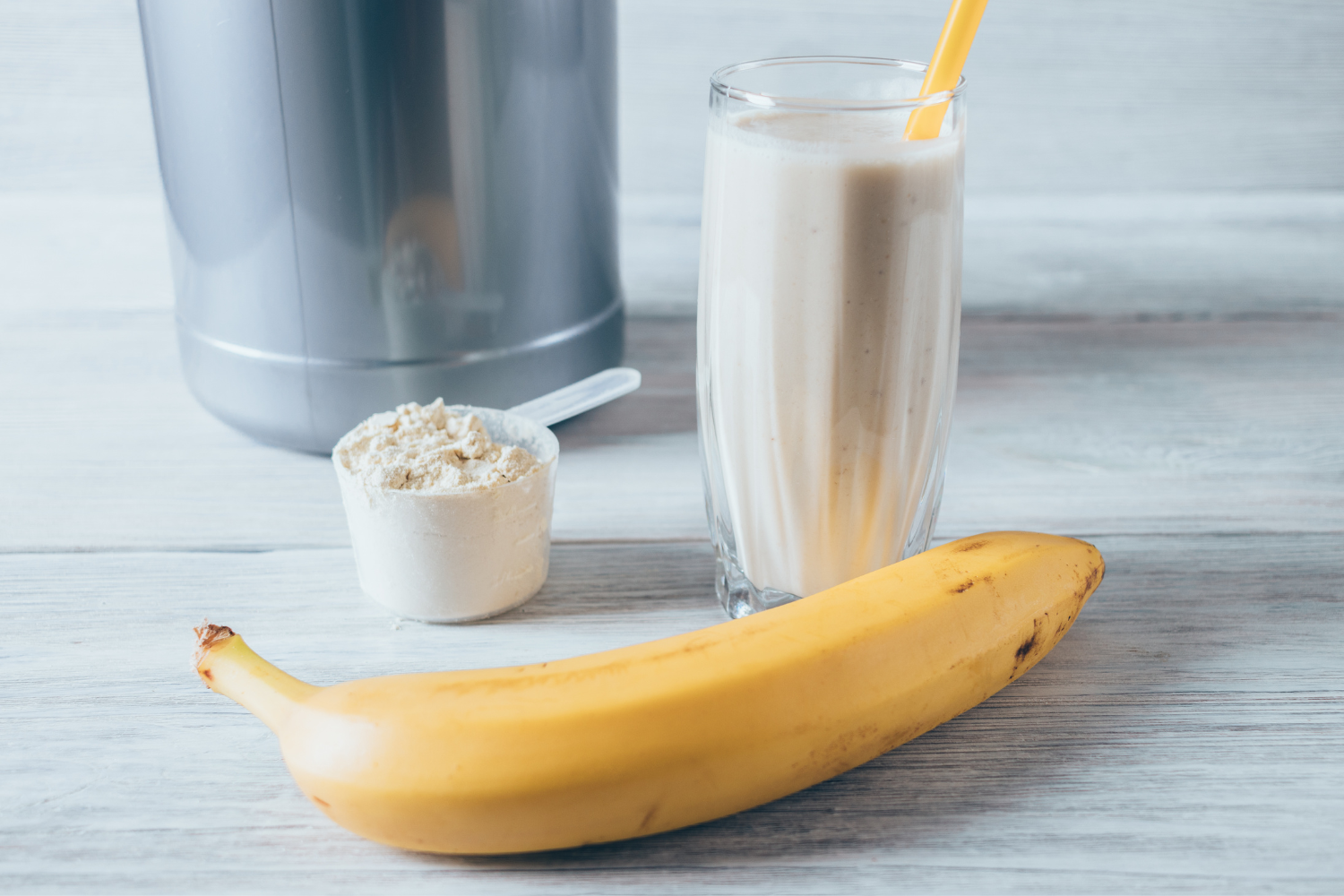 Protein shakes with powder and a piece of banana.