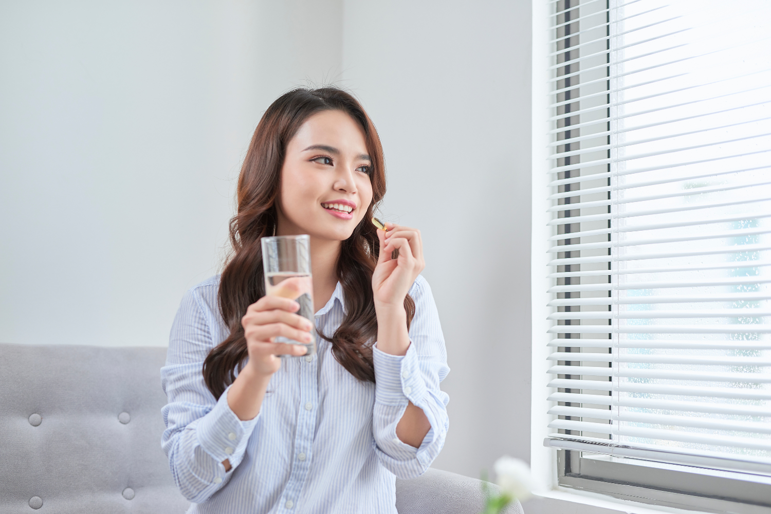 Woman about to take her supplements.