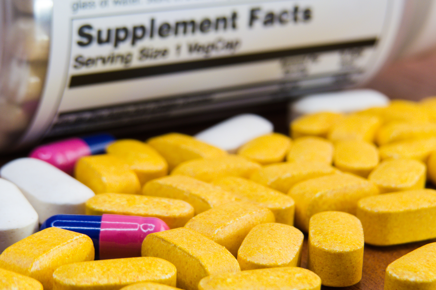Tablets with supplement facts label on the background.
