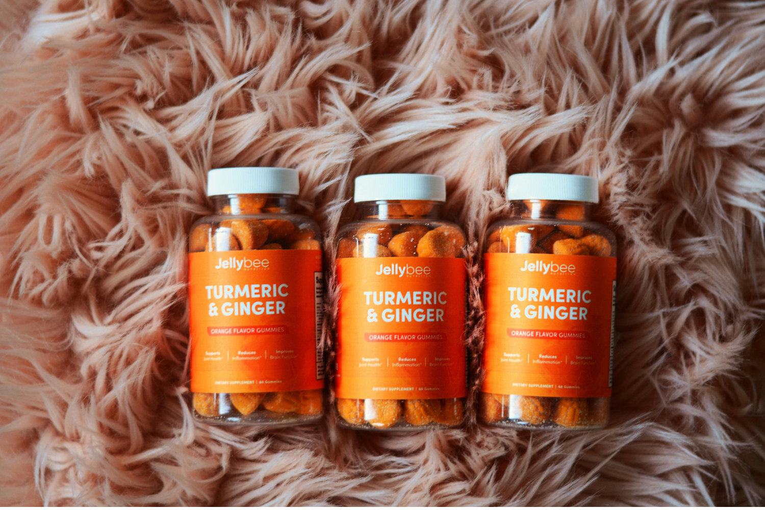 Three orange supplement bottles.