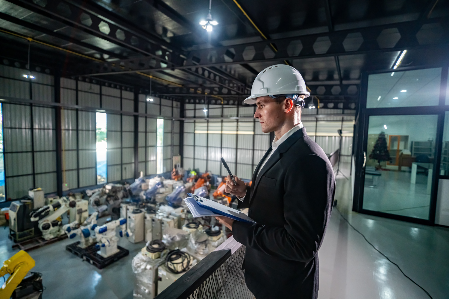 An auditor holding a clipboard inside a facility.