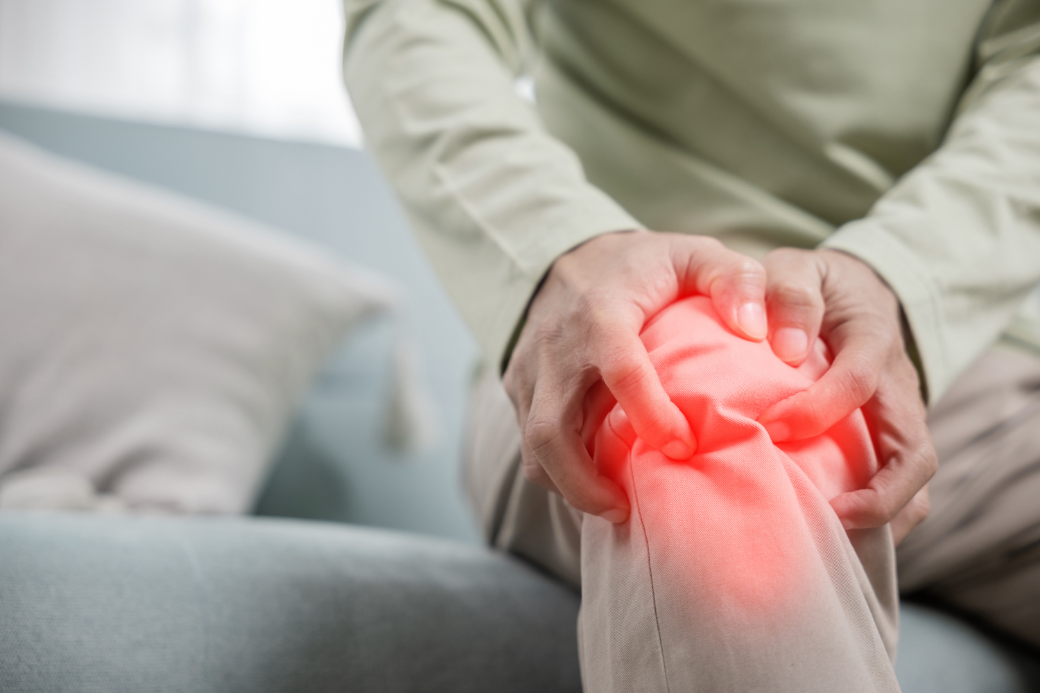 Person holding their inflamed knee.