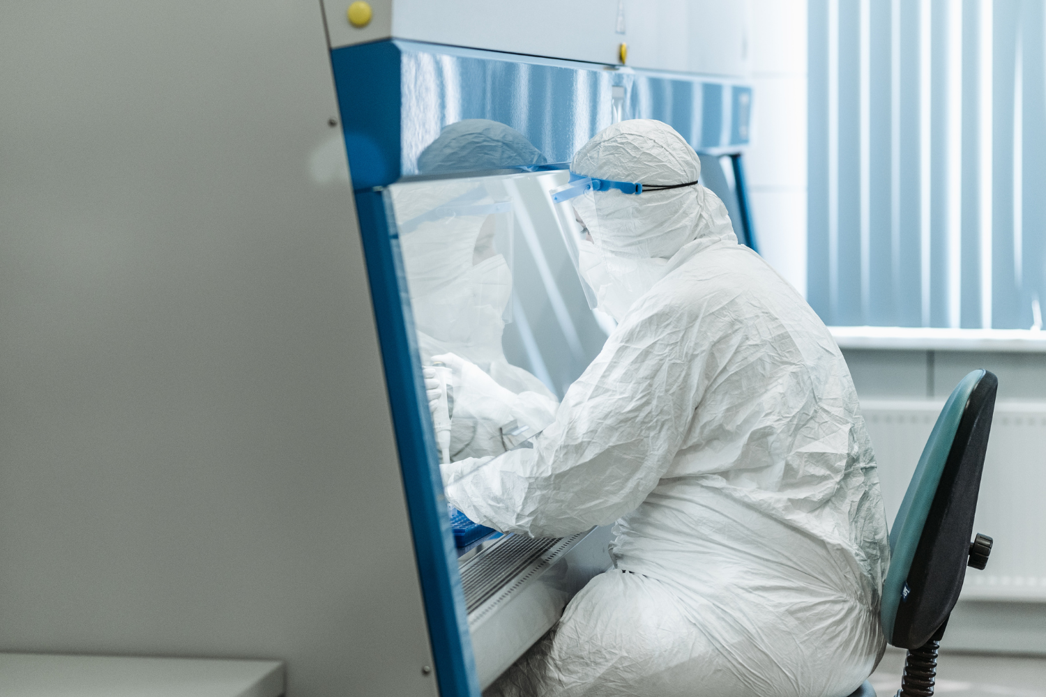 Lab worker in PPE.