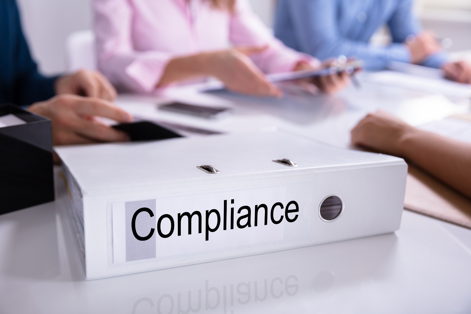 Compliance book with professionals.