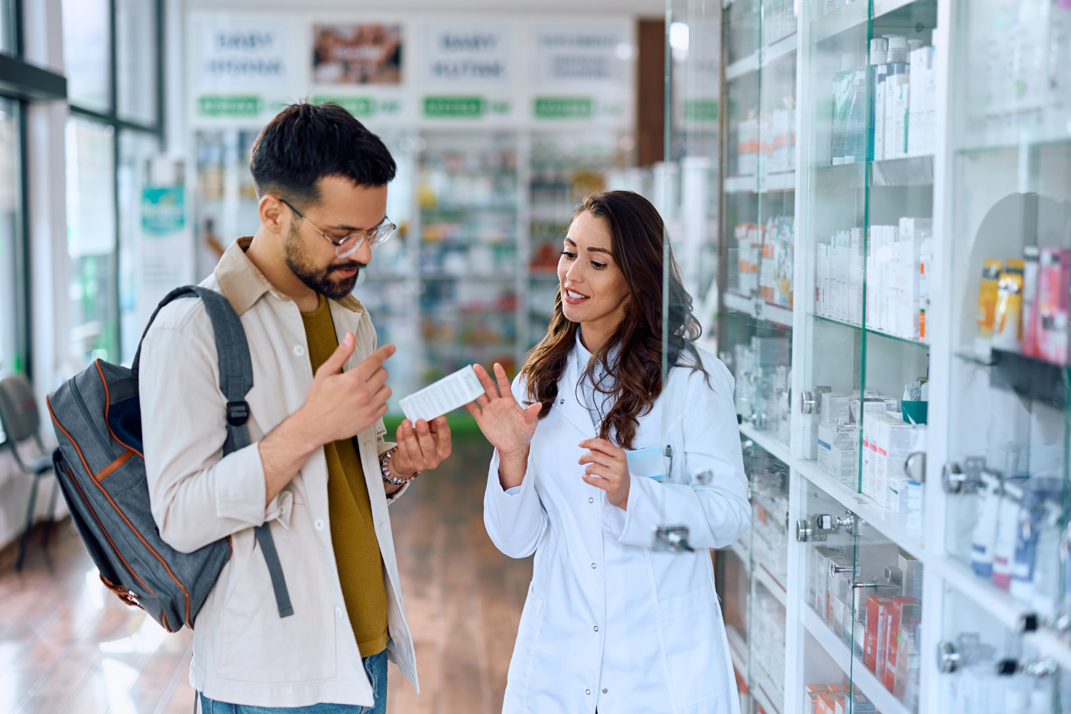 A consumer choosing supplements in a pharmacy.