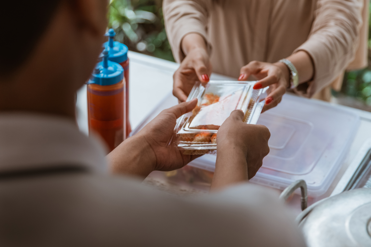 Person giving a product to another.