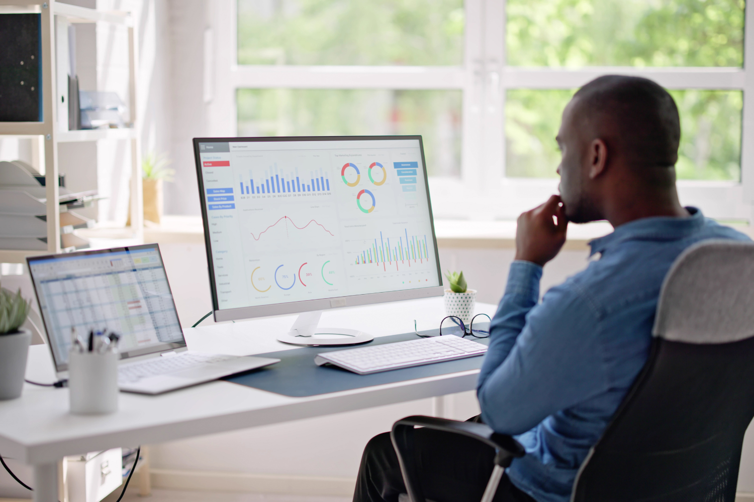 A professional reviewing nutrition product charts and data on a laptop.