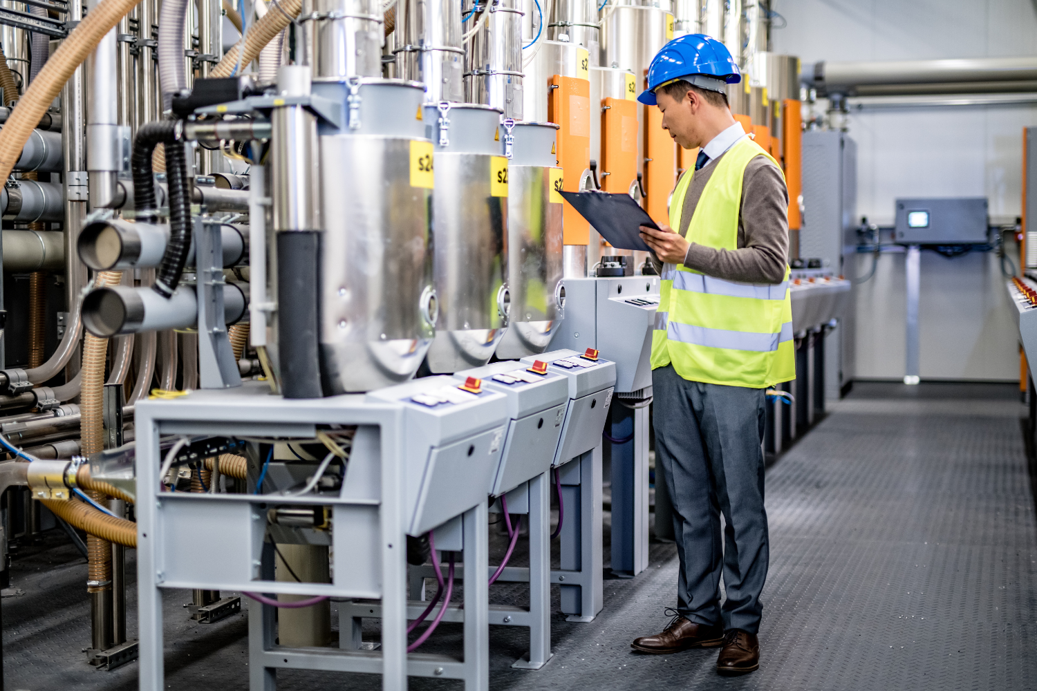 A facility worker checking machines.