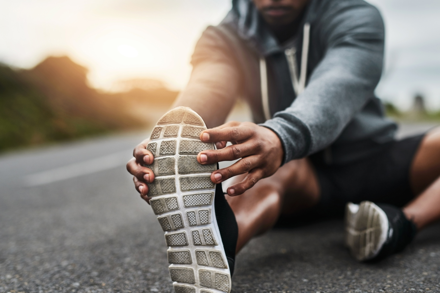 An athlete stretching their hamstrings.