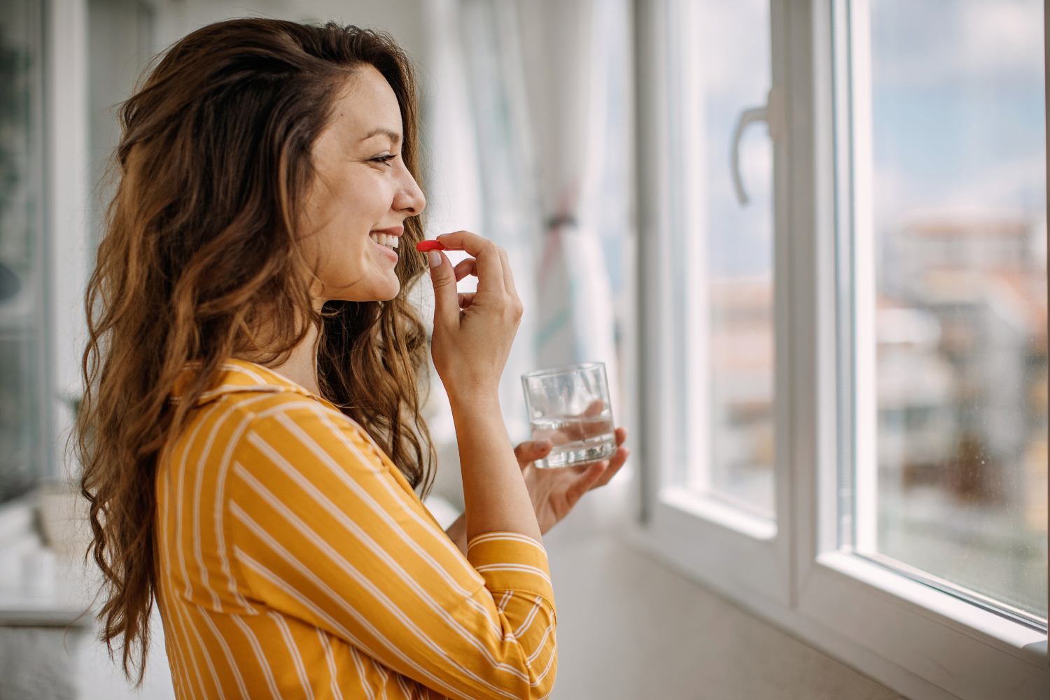 Woman taking supplements.