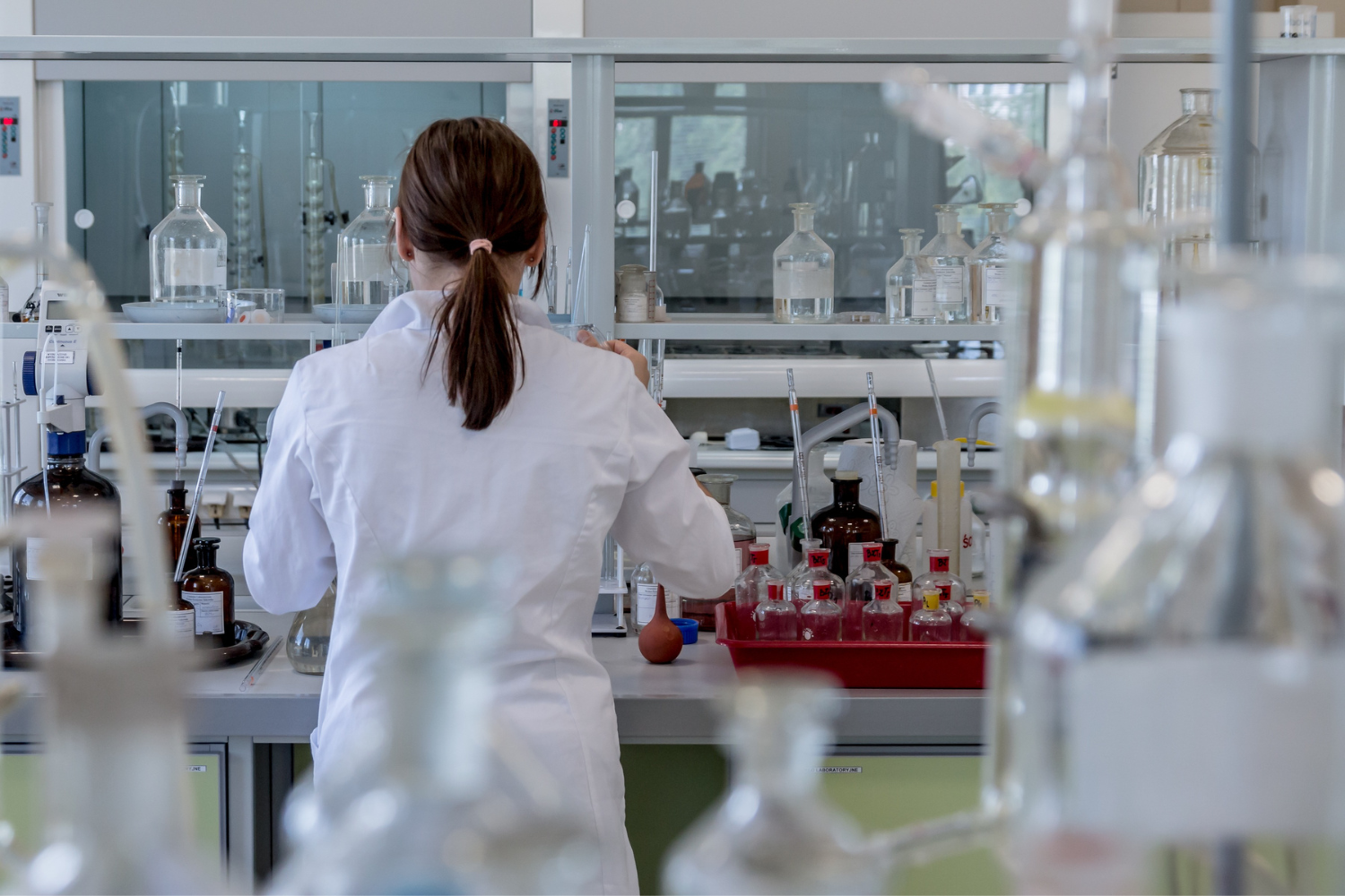 A nutritionist examining raw supplement ingredients in a laboratory setting.
