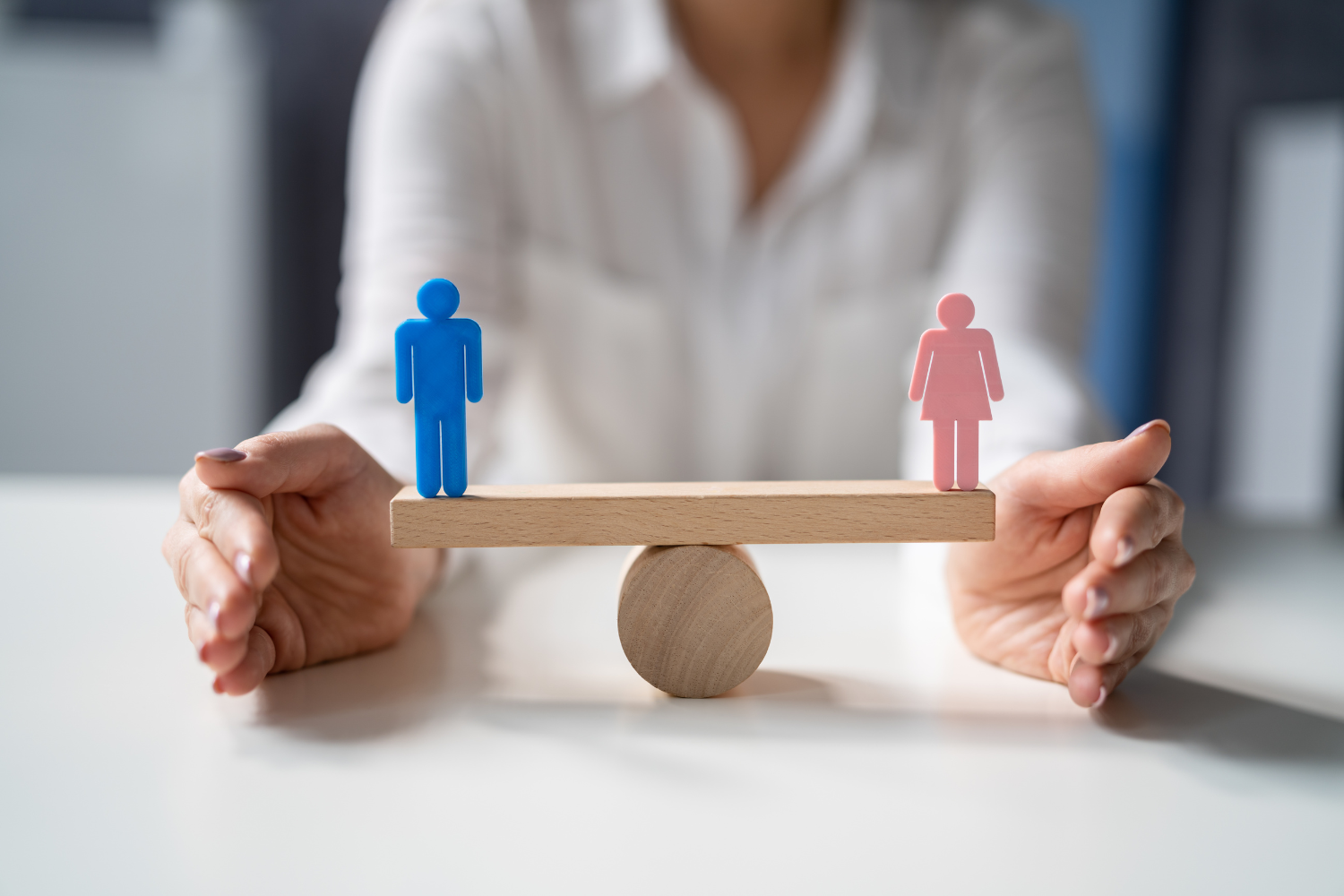 Wooden scale with male and female models on each side.