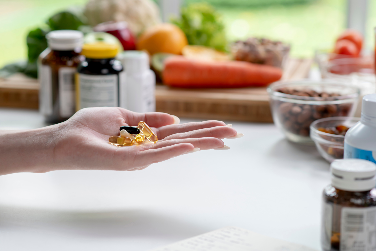 Hands holding various types of supplements.