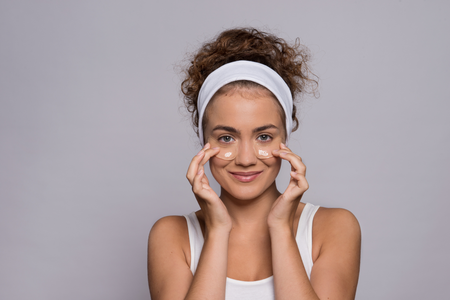 Woman with skincare products on her face.
