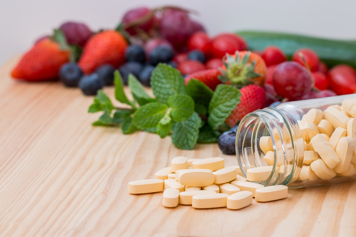 A bottle of multivitamins with frutis on its background.