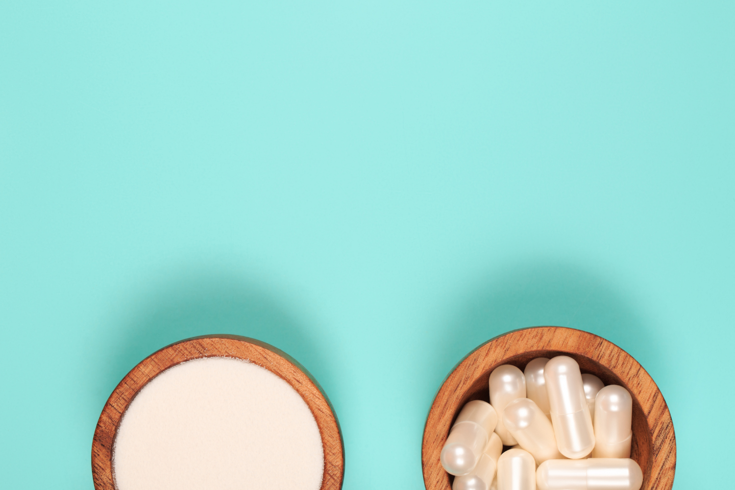 A bowl of powder and capsule supplements.