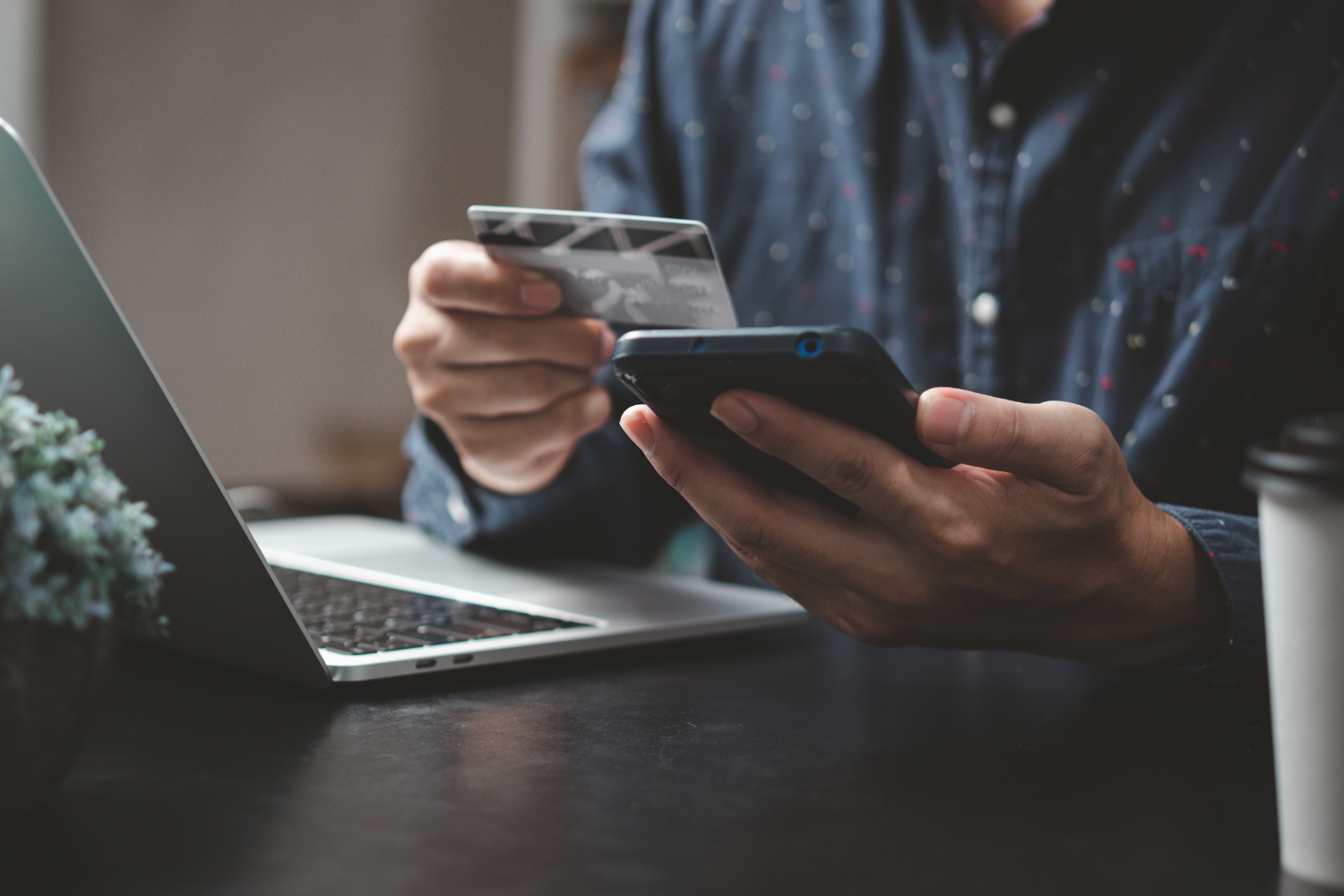 Person inputting card details on e-commerce platform.