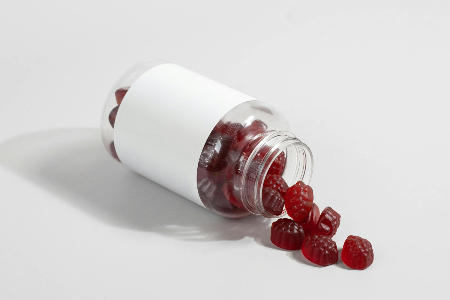 Gummy supplements with blank supplement packaging.