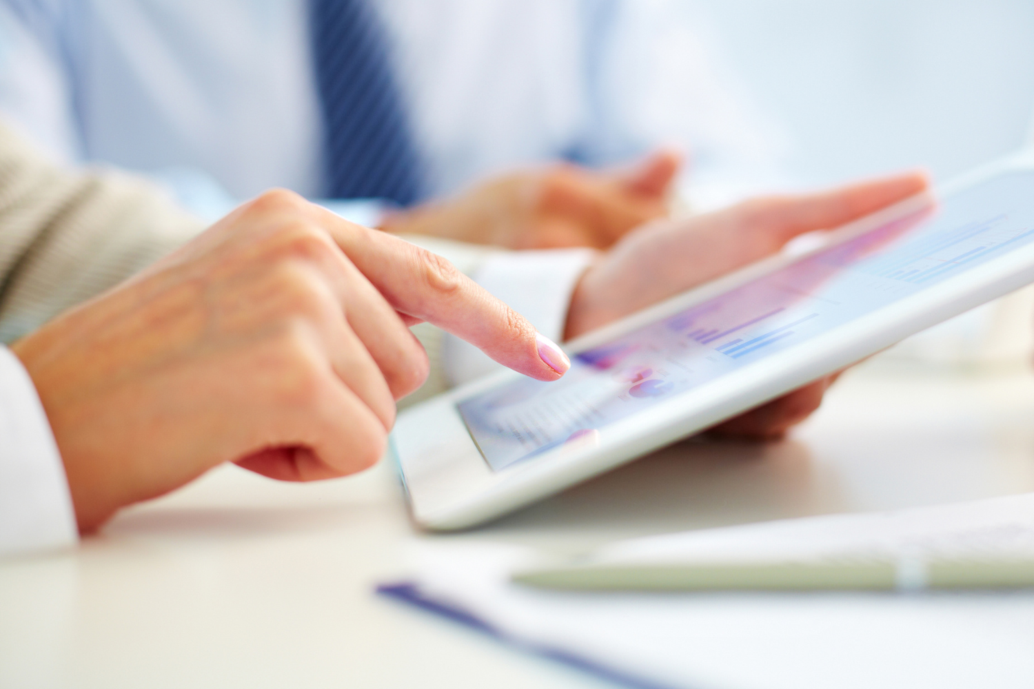 Person holding and using a tablet.