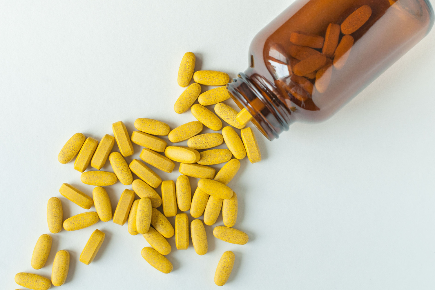 Vitamins spilling from bottle.