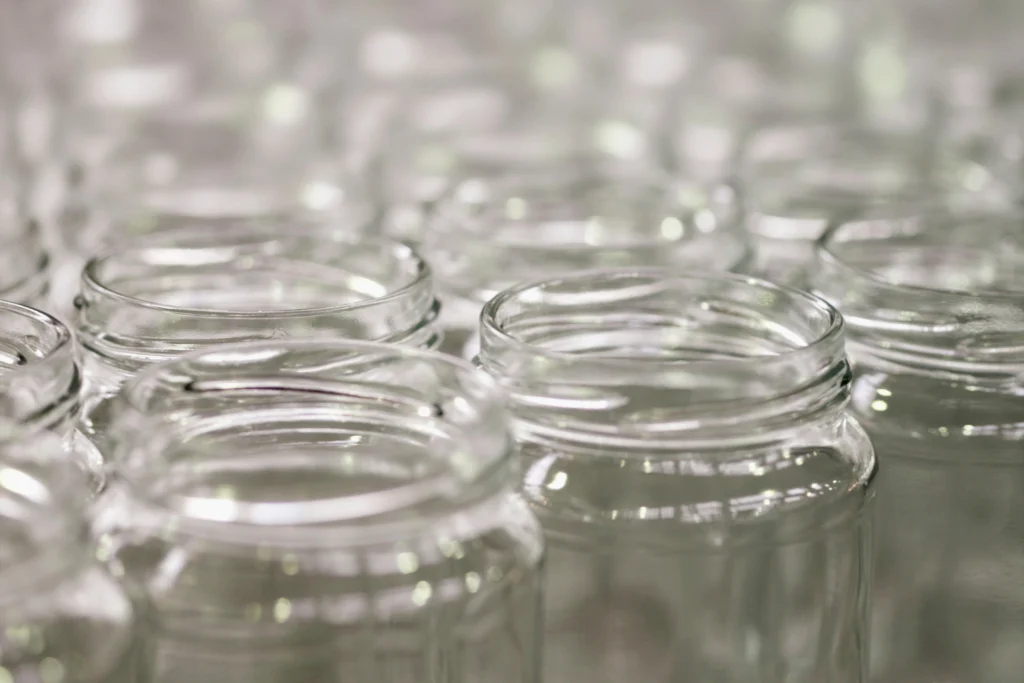 A close-up of clear glass supplement jars.