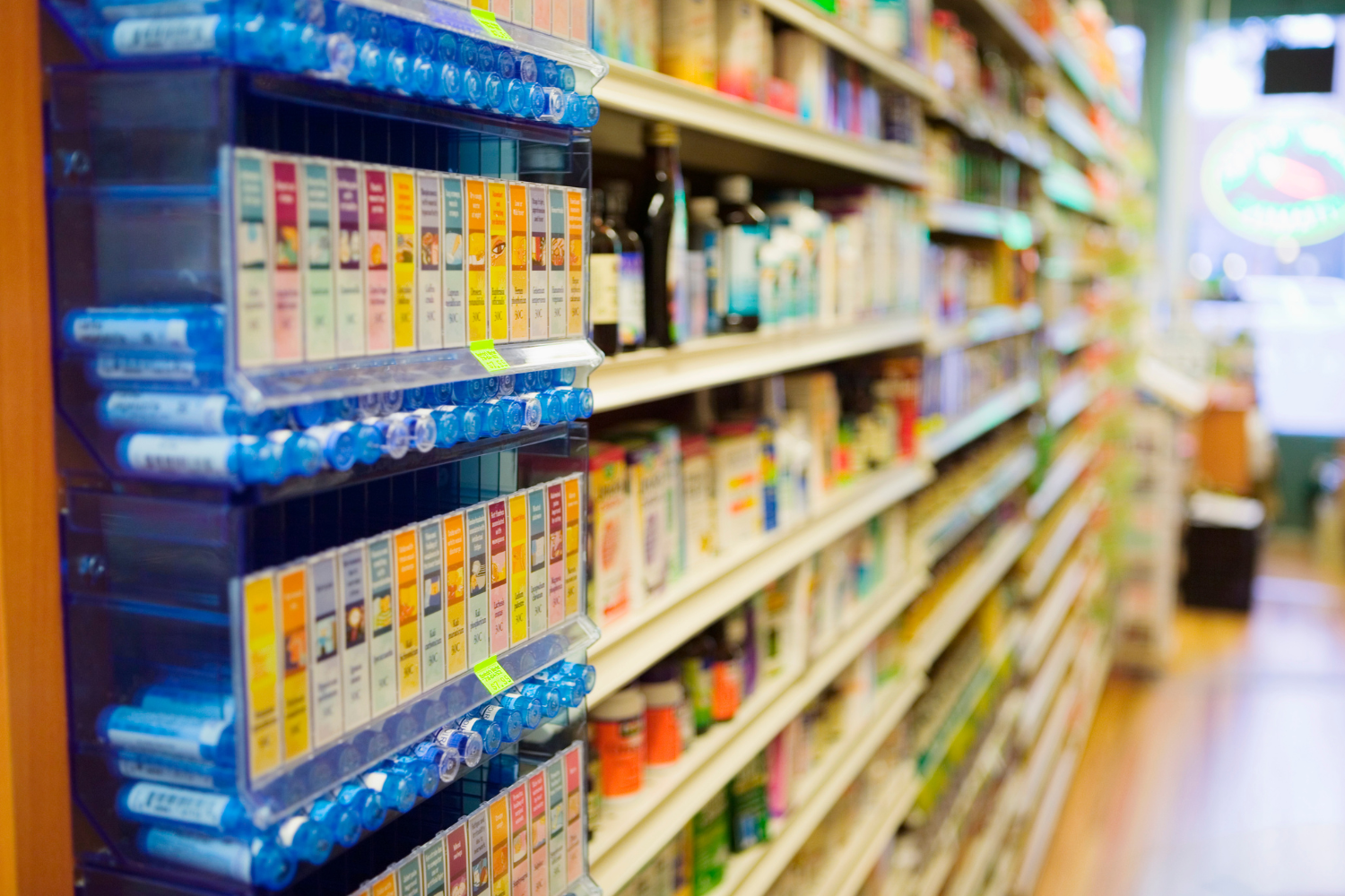 A neatly arranged shelf in a retail store showing products with tamper-evident seals and branded packaging.