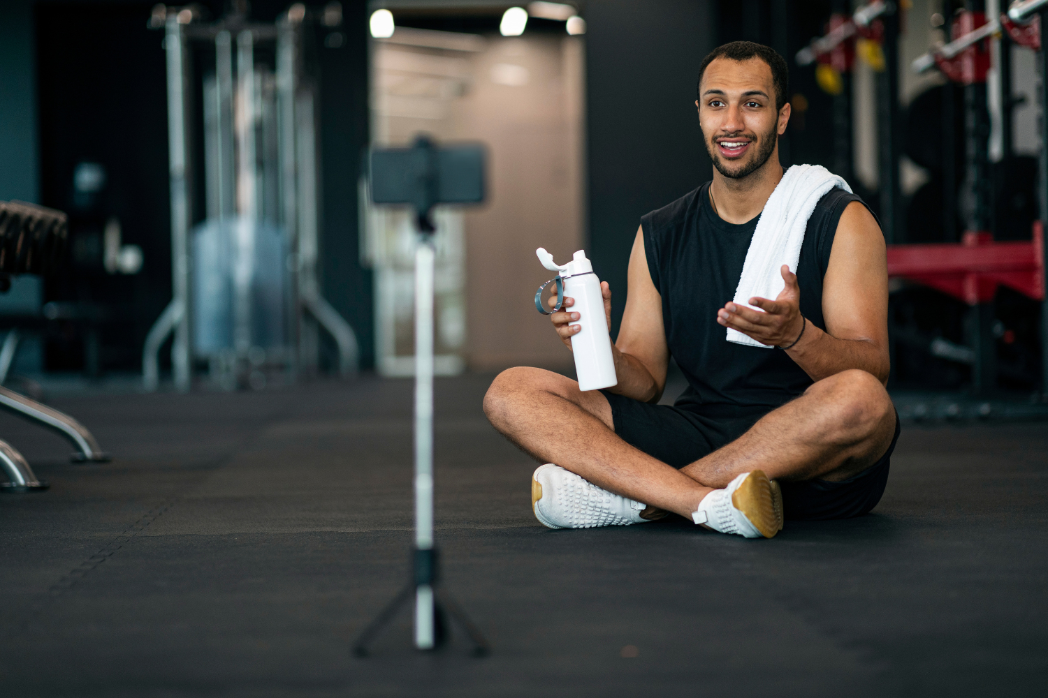 A fitness influencer recording a video review of sports supplements for social media..