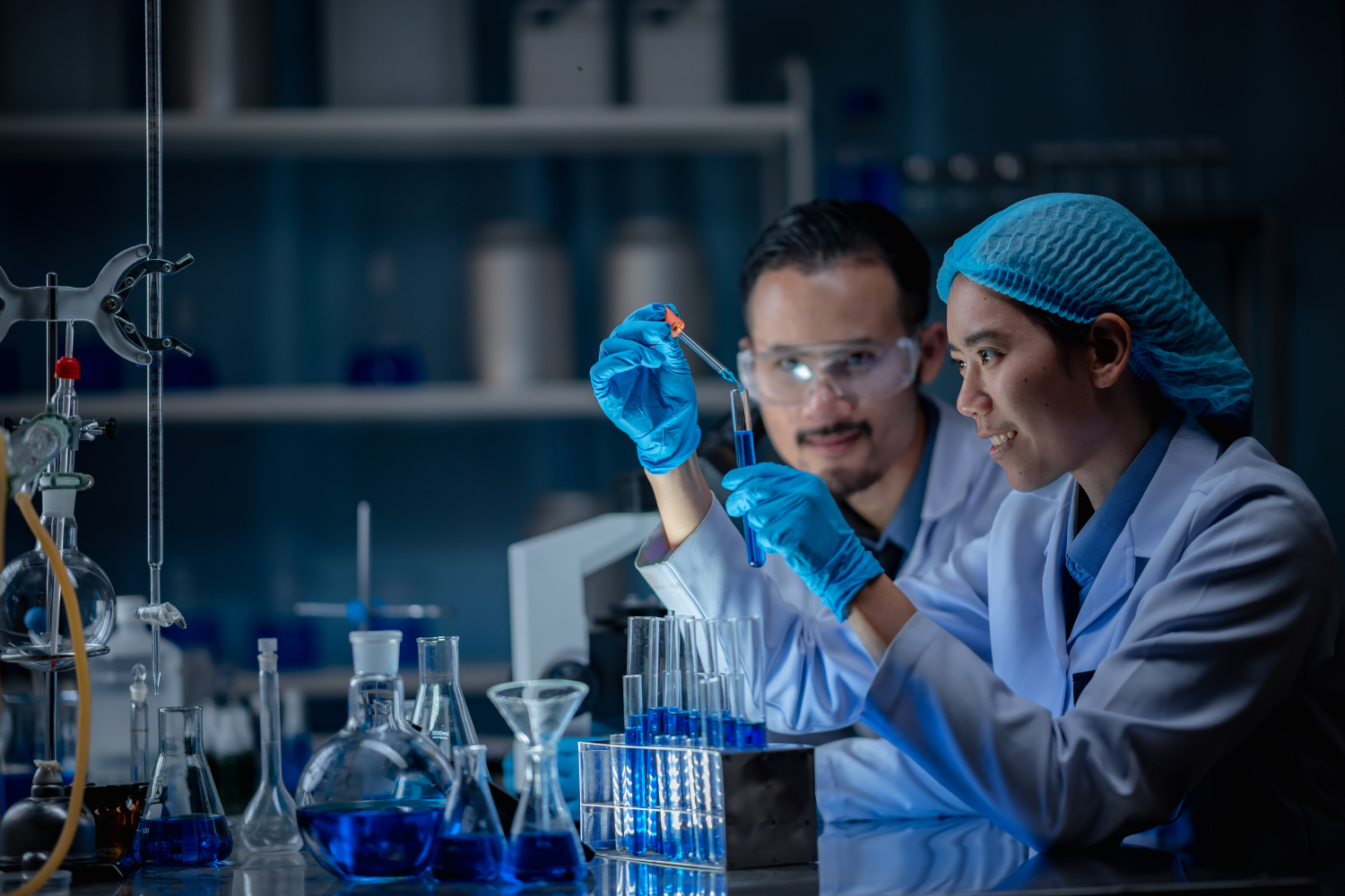 A lab with scientistists working on formulas.