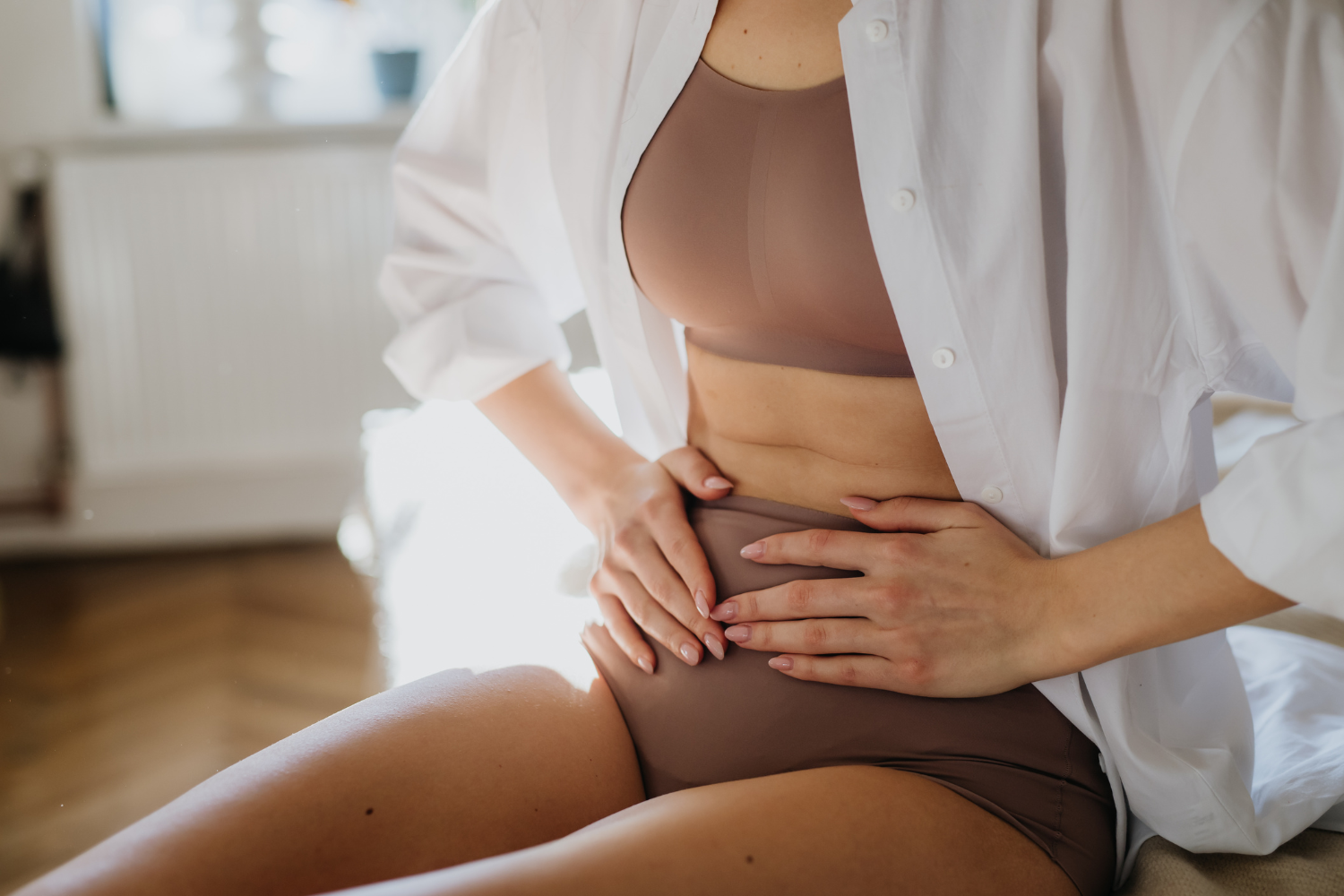Woman holding stomach.