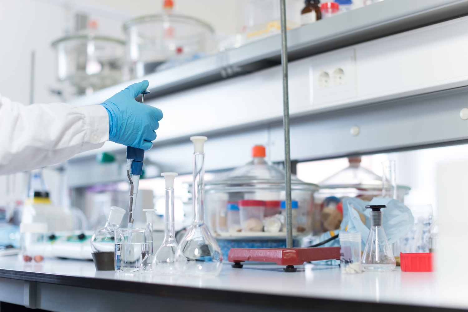 A scientist in a lab coat testing vegan supplement formulations.