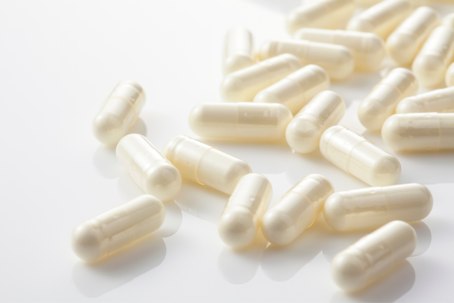White supplements on a white surface.