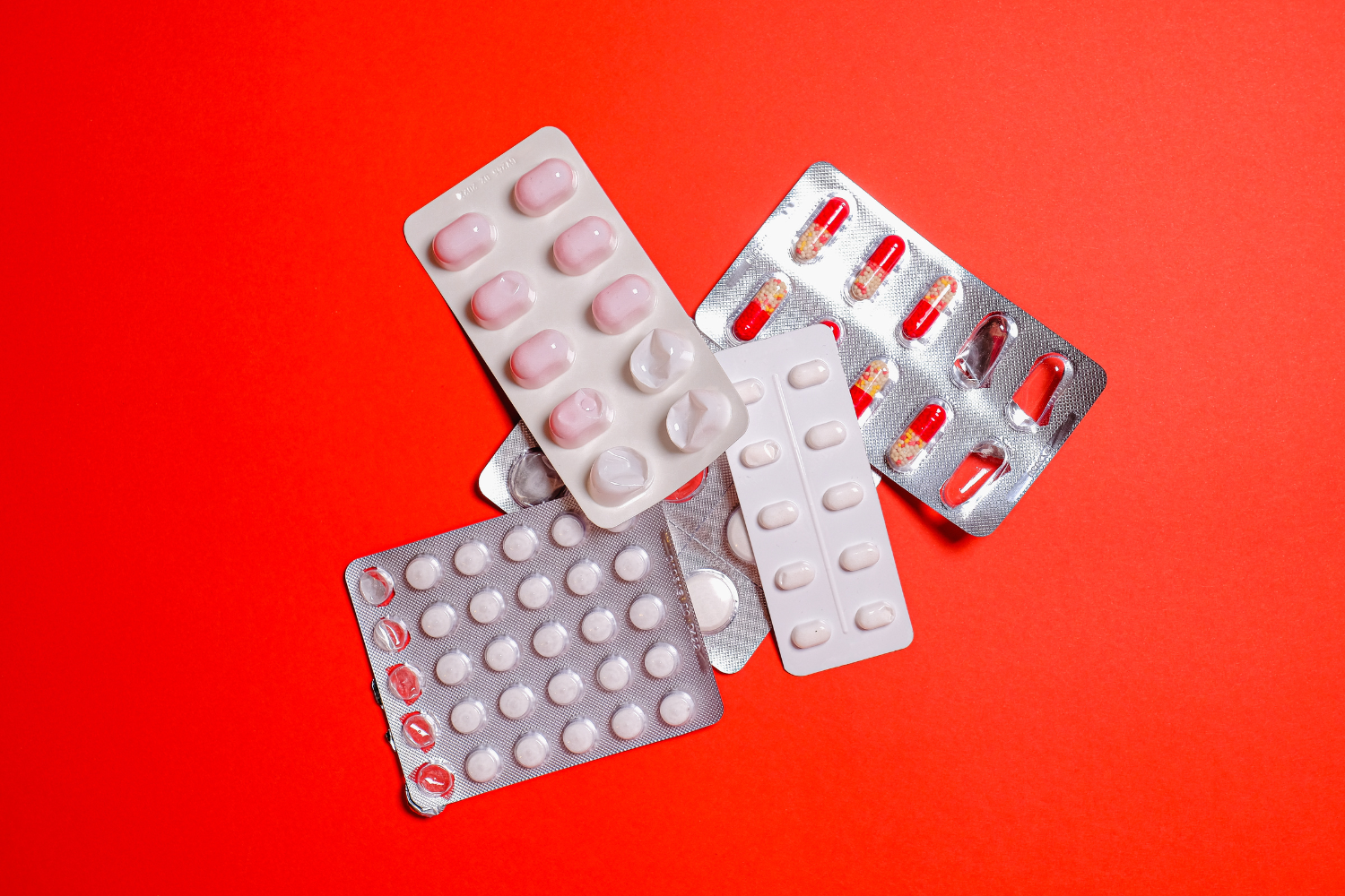 Image of round and oval tablet supplements in blister packs.
