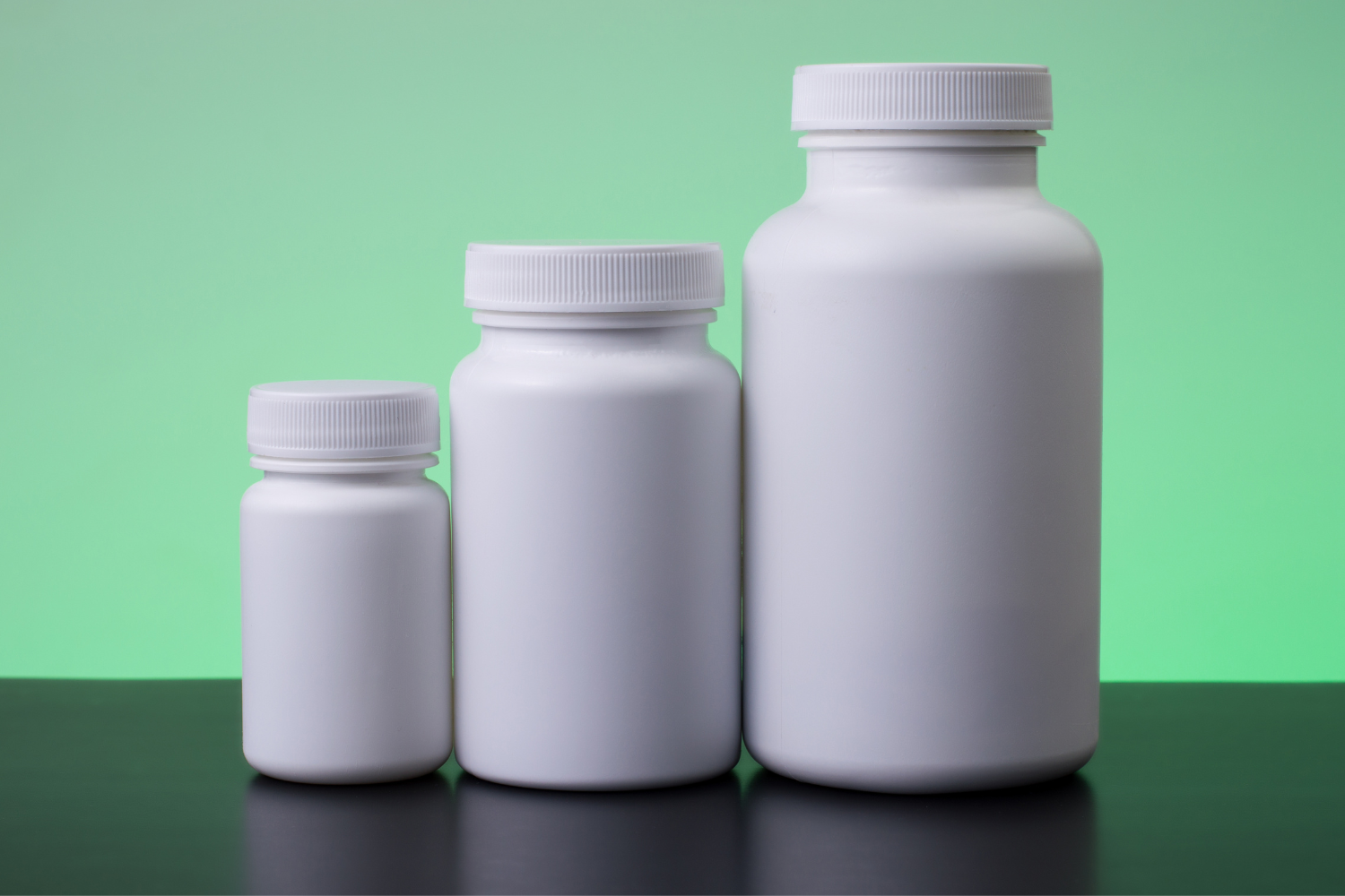 Multiple supplement bottles with blank labels, ready for branding.