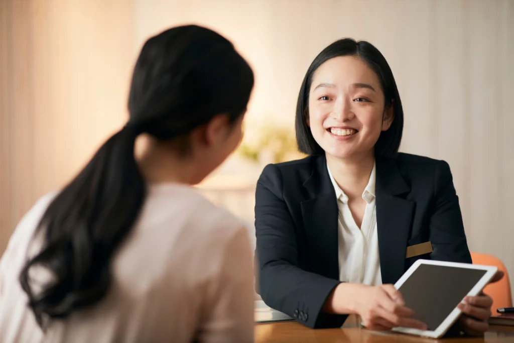 Businesswoman discussing cost savings with a client using a switch manufacturer cost savings calculator.