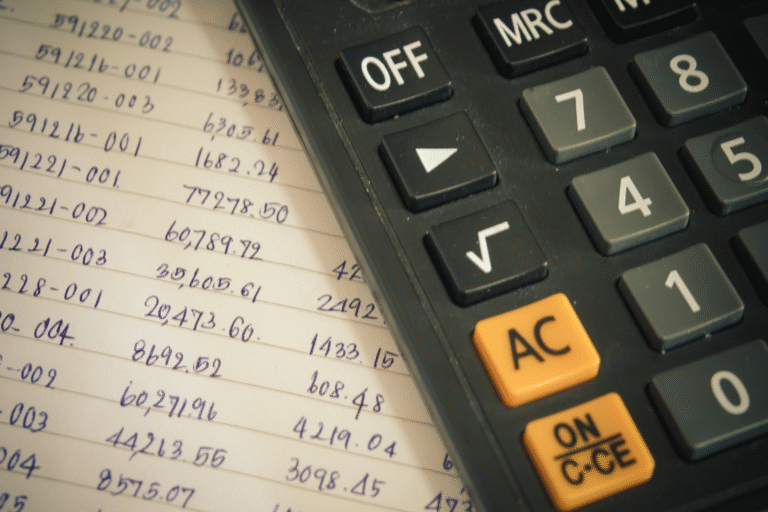Close-up of a calculator with handwritten costs for a switch manufacturer cost savings calculator.