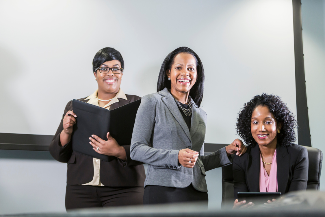 Corporate supplement manufacturer team of professionals smiling in office.