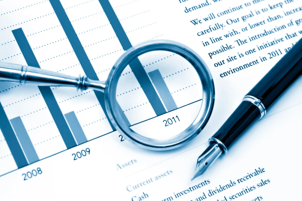 Business report with bar chart and magnifying glass showing supplement manufacturer quality control data