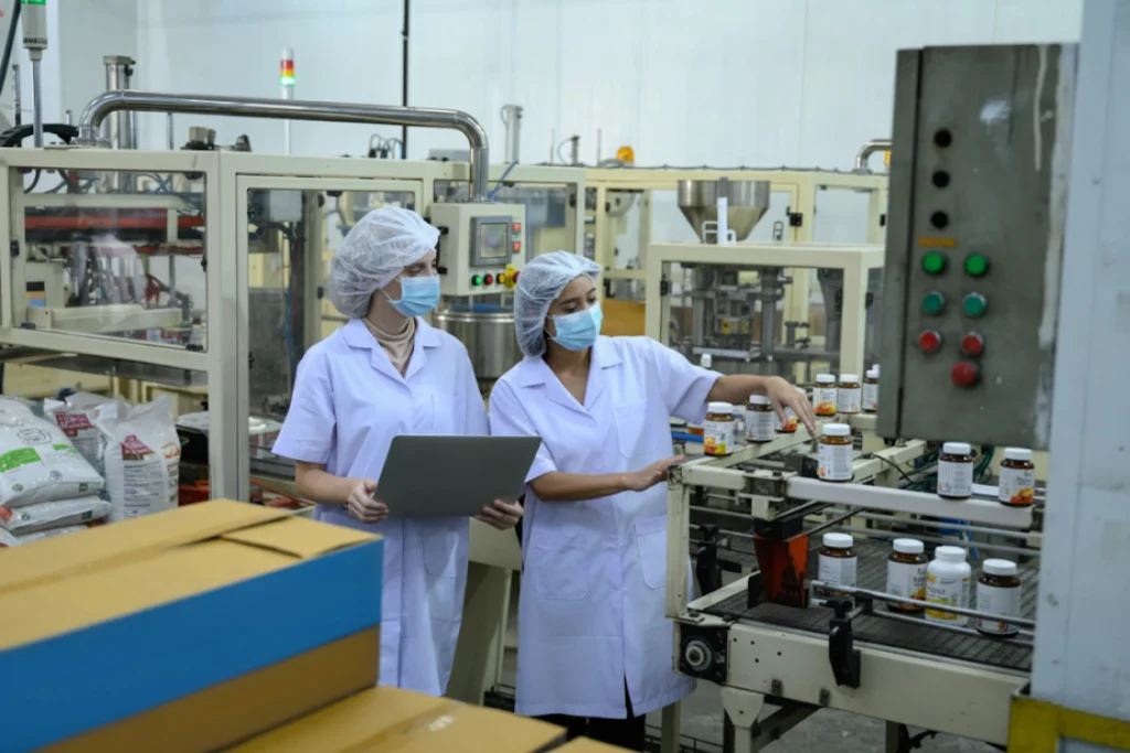 Quality control team verifying supplement production in a factory.