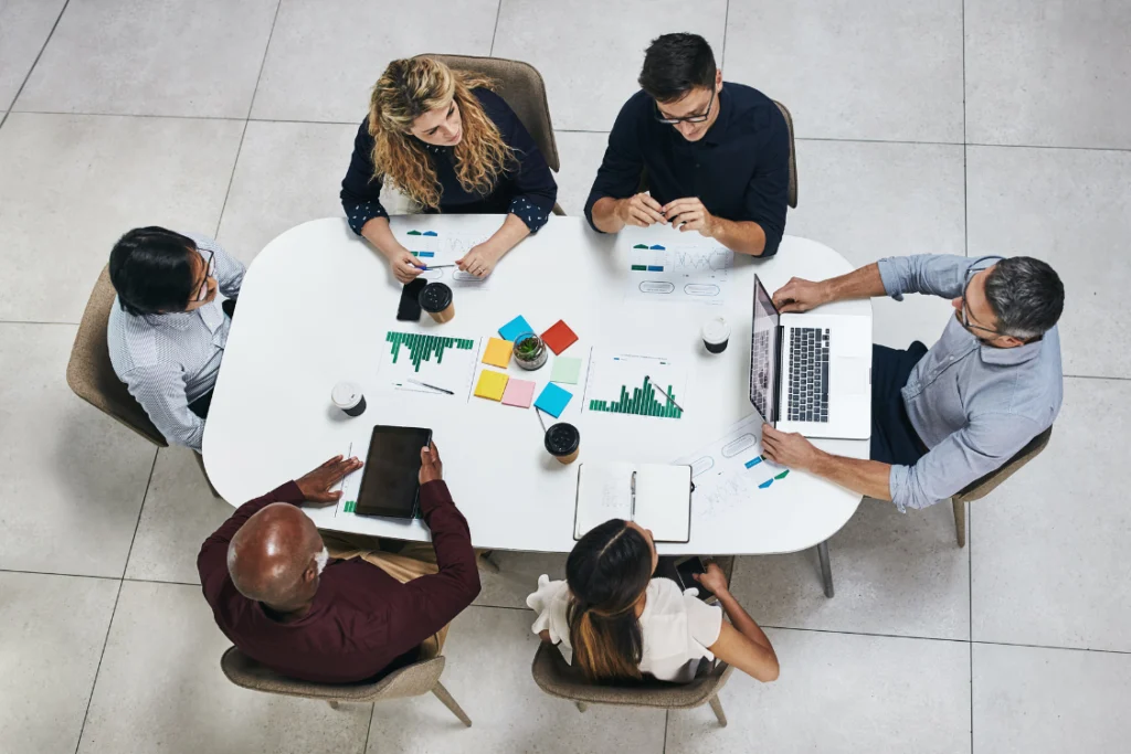 Team discussing supplement manufacturer strategy during office meeting.