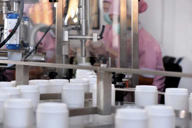 Supplement jars filled on production line showing manufacturer track record in consistent delivery