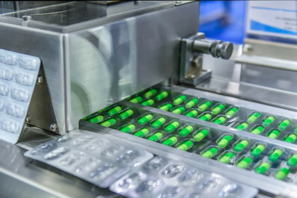 Capsules being packaged in supplement manufacturing facility highlighting track record in quality control